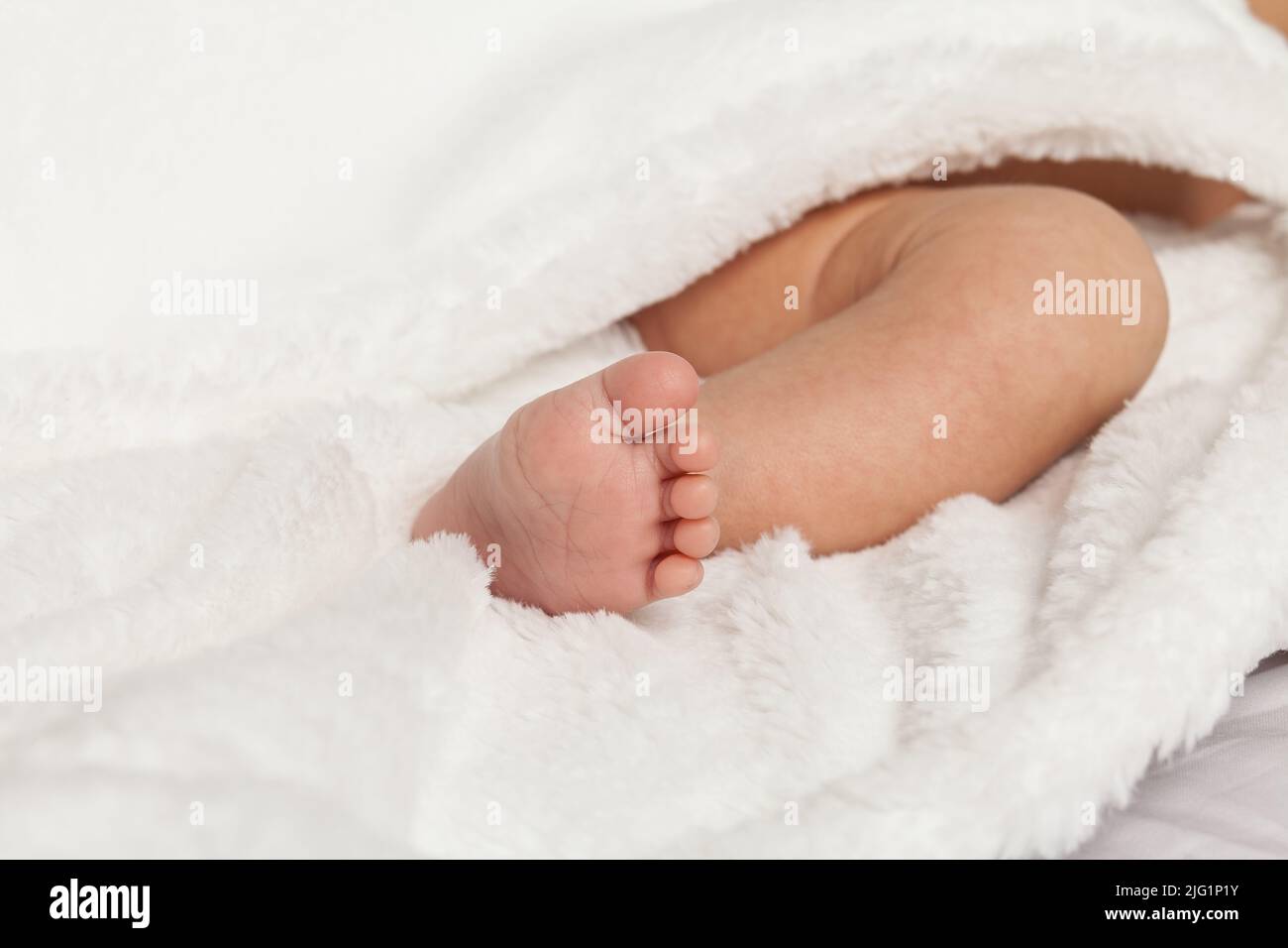 Close-up photo; photo of the foot of a newborn baby. Stock Photo