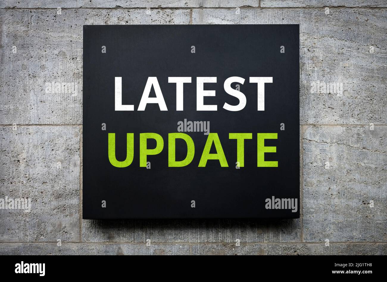 Latest Update - words on wall board Stock Photo