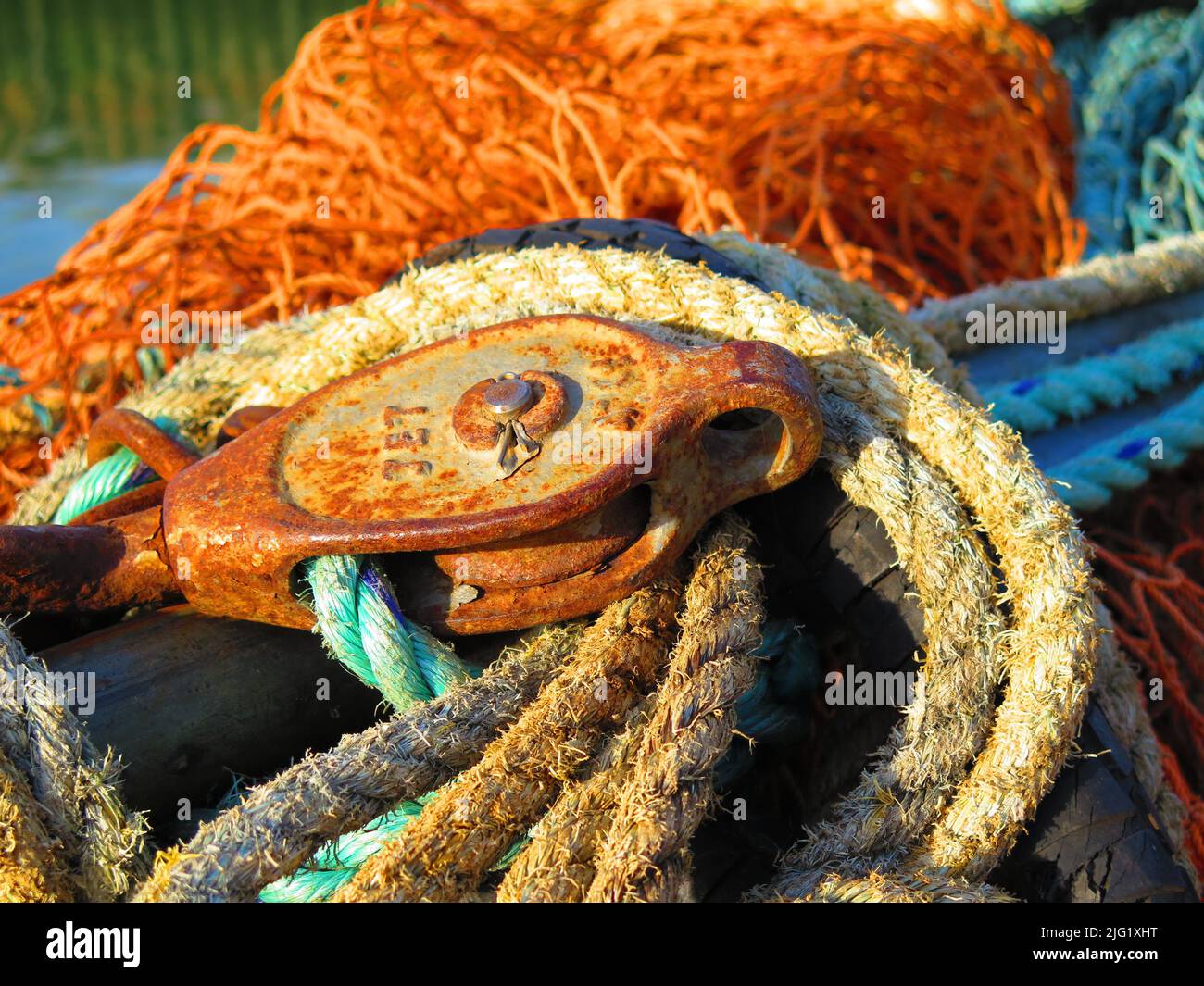 Yellow, rusty and blue mooring lines. Fishing nets, fishing industry