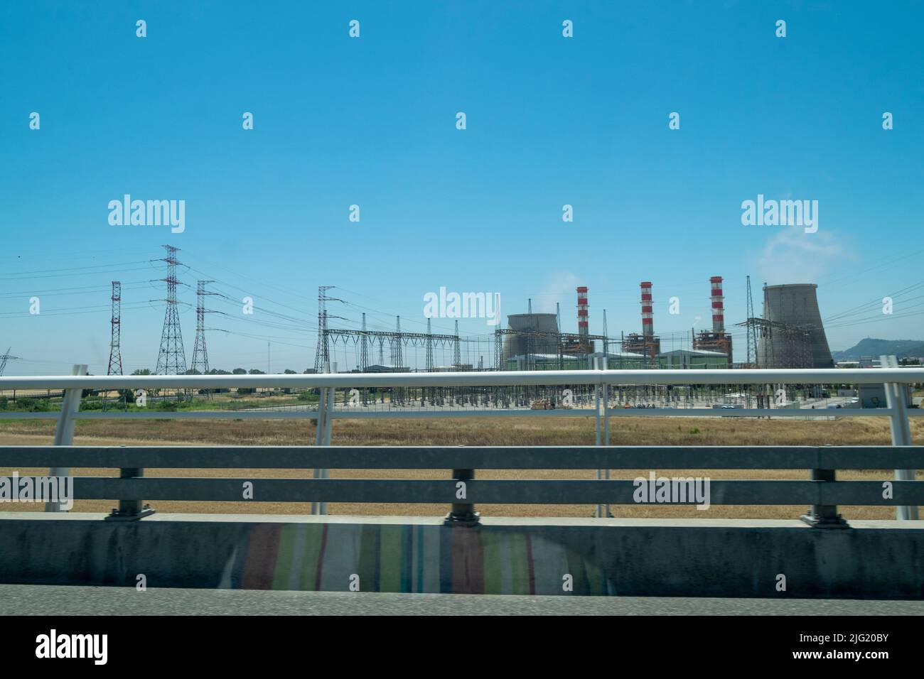 Industrial facilities view from motorway. Big industrial complex. Economy and production. Modern countries. Stock Photo