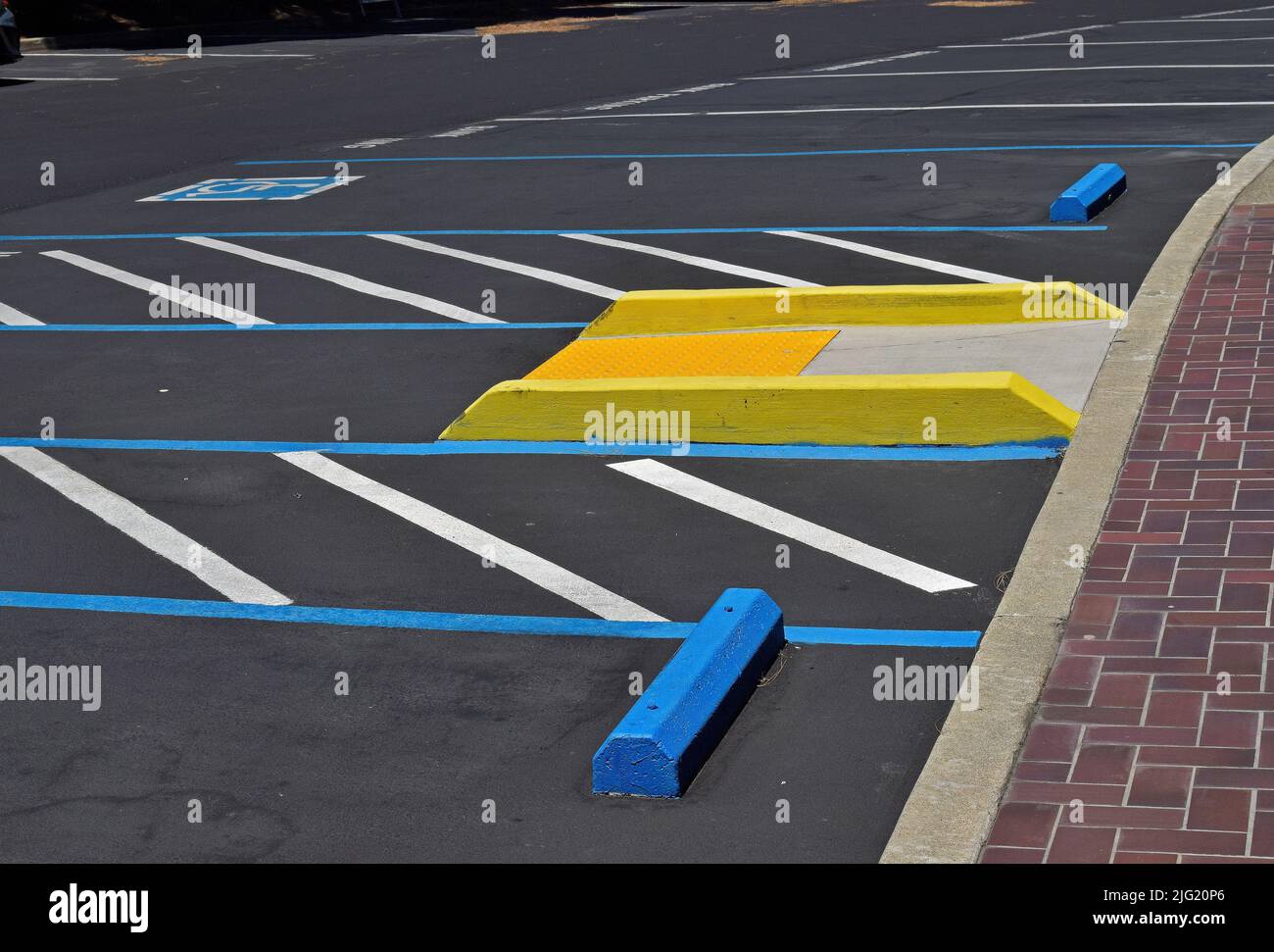 handicapped parking and yellow ramp in parking lot in Pleasanton