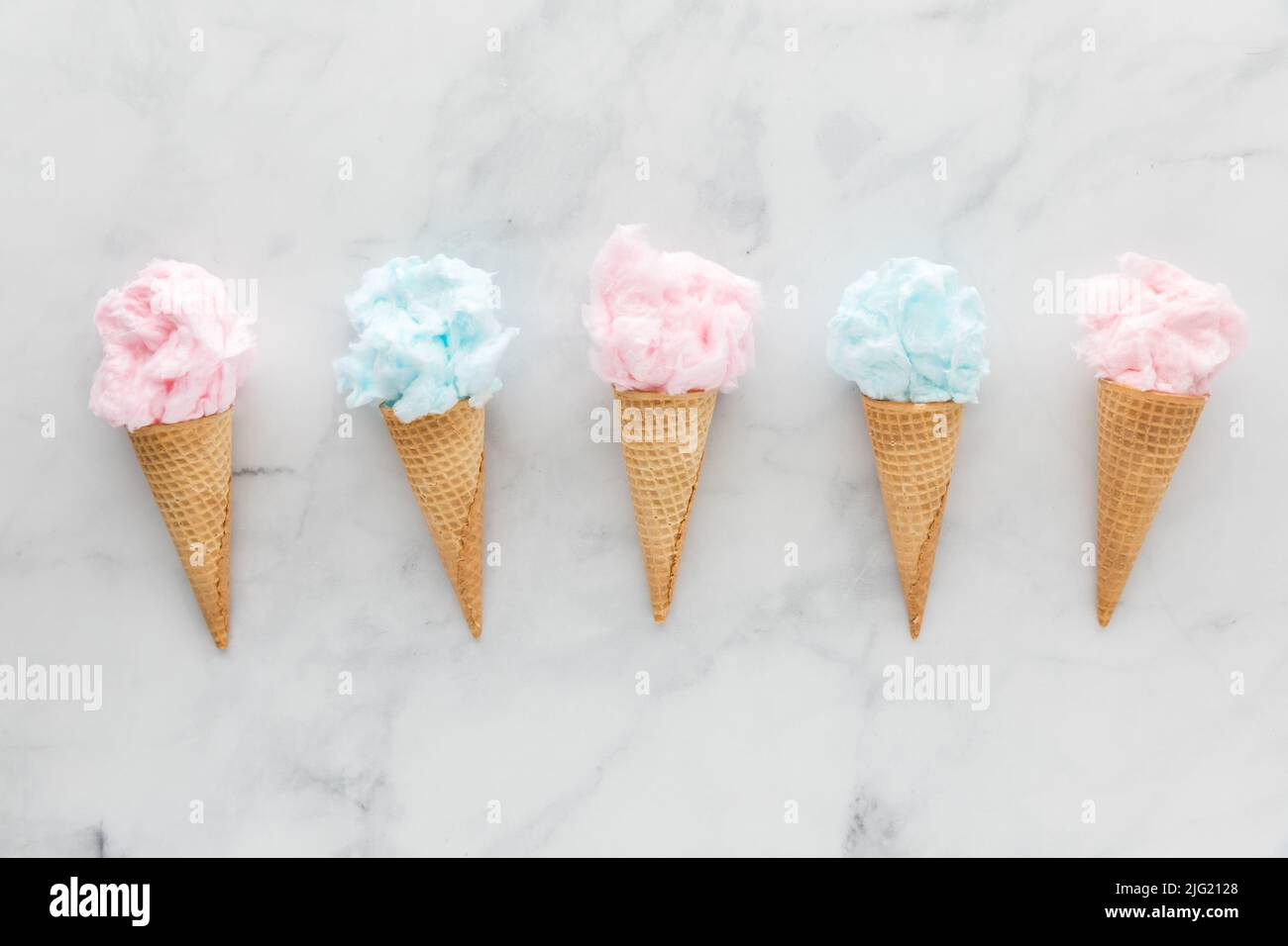 A row of waffle cones filled with cotton candy. Stock Photo