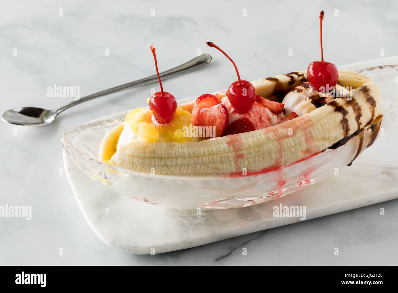 Banana split ice cream dessert topped with maraschino cherries. Stock Photo