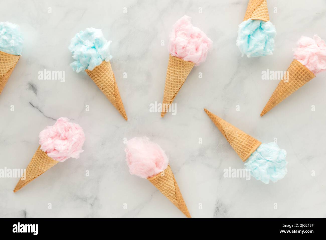 Several waffle cones filled with cotton candy scattered about. Stock Photo