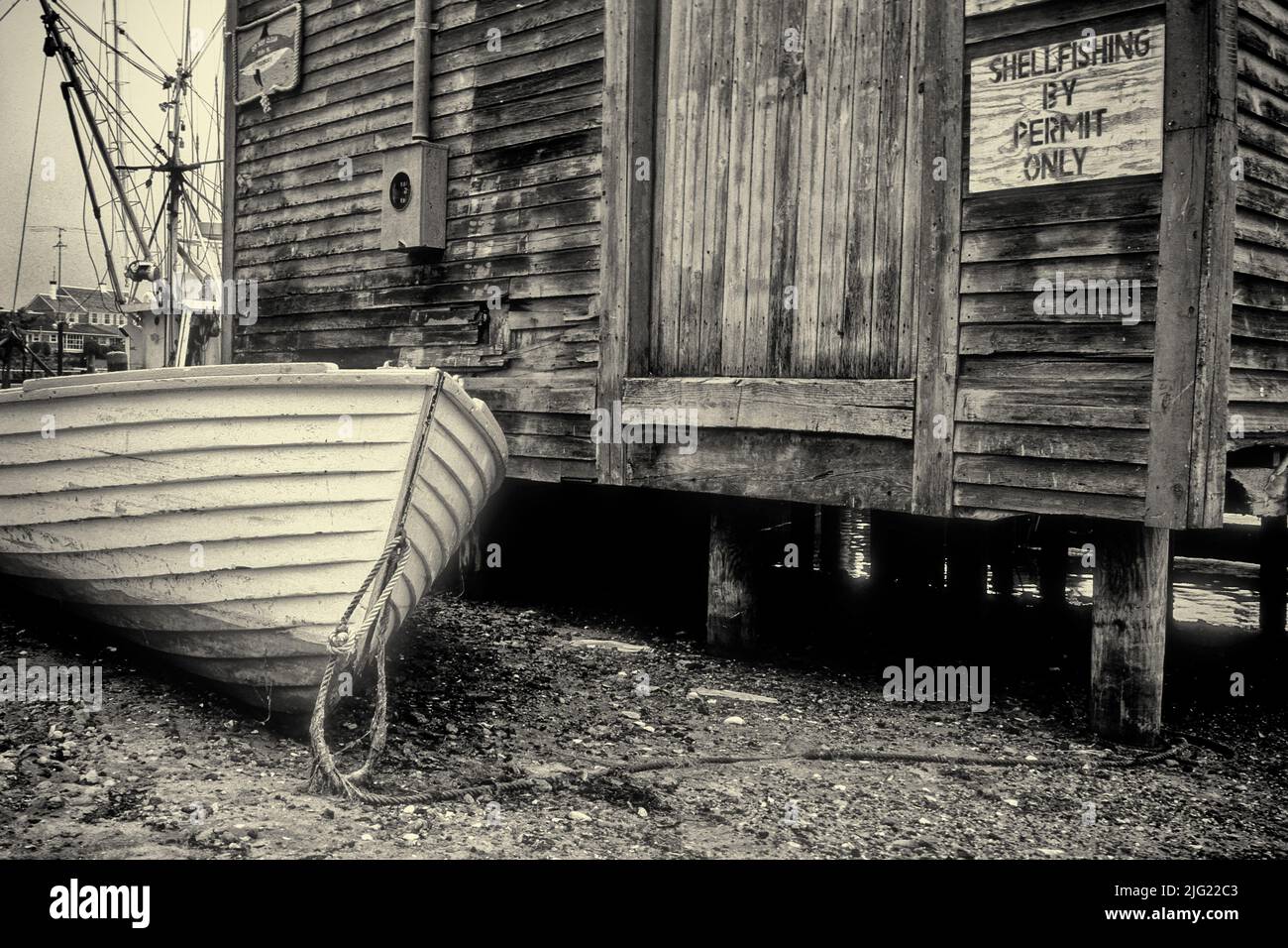 An old boat and building near the water on Cape Cod Stock Photo