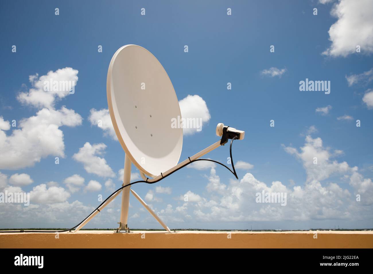 Satellite dish on blue sky background. Parabolic antenna. Reception of the Internet signal from satellites. Stock Photo