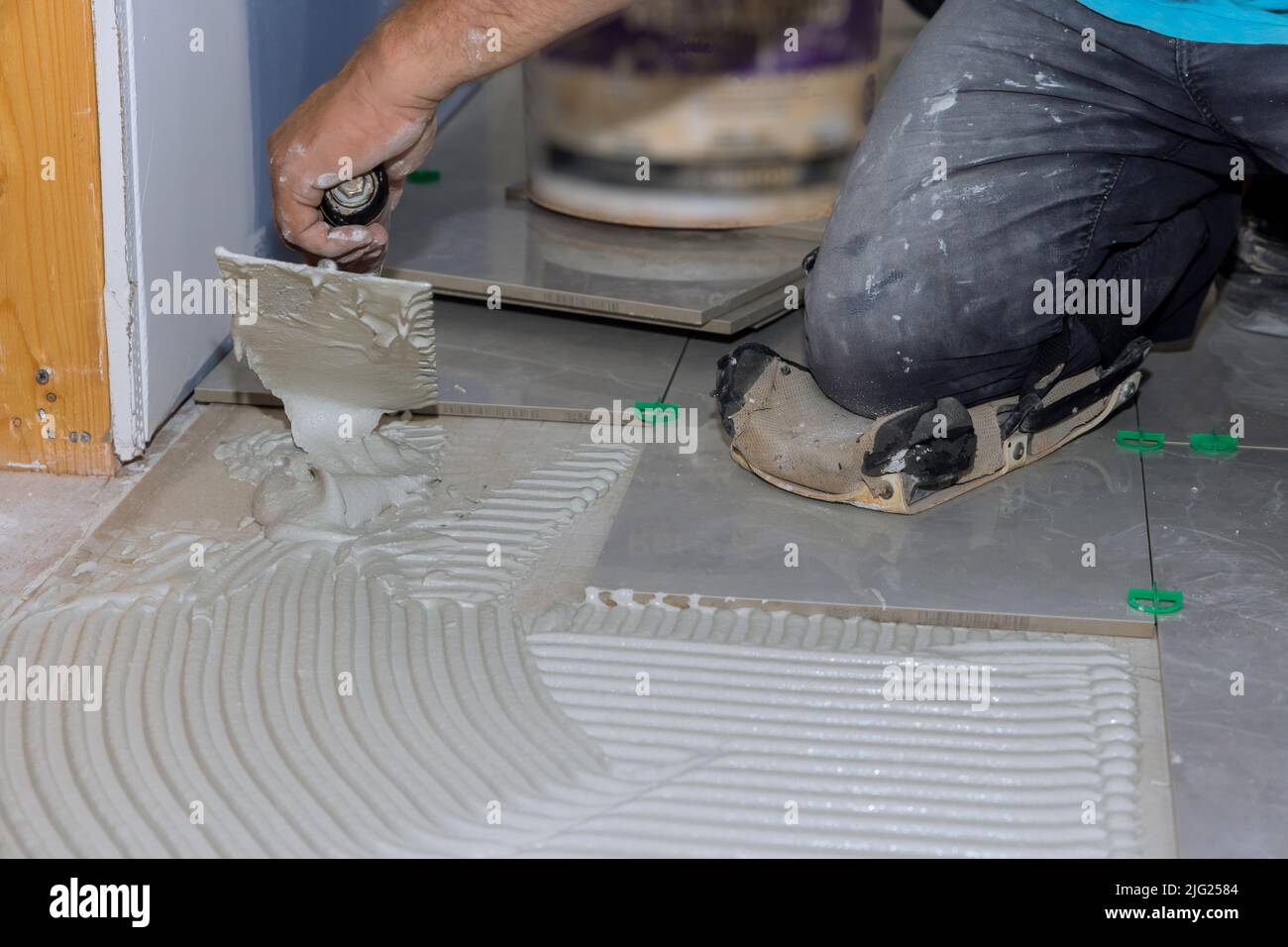 Before adding tiles to a bathroom floor, it is necessary to spread wet