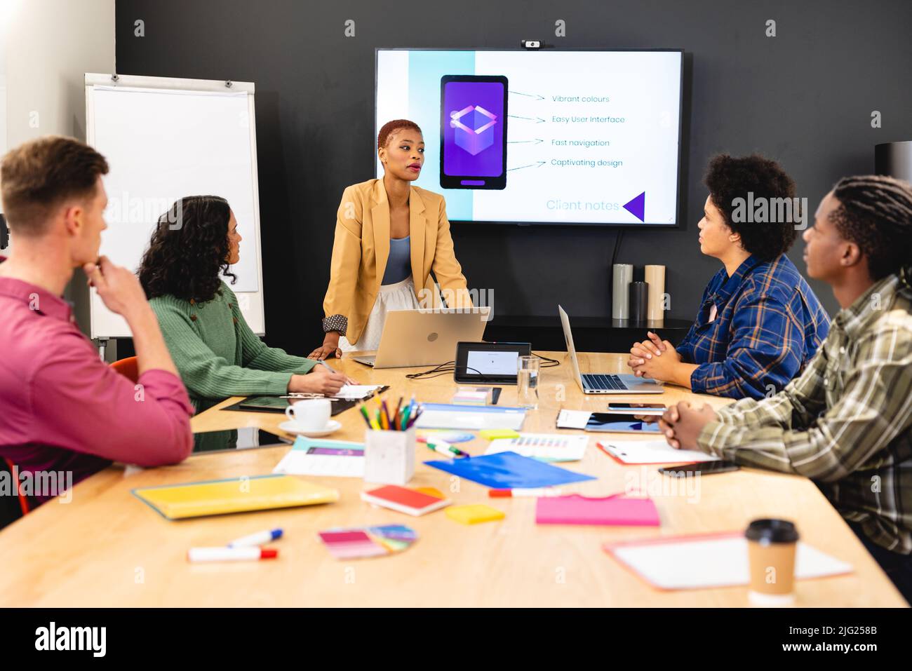 African american female manager discussing ideas with app developers in meeting at office Stock Photo