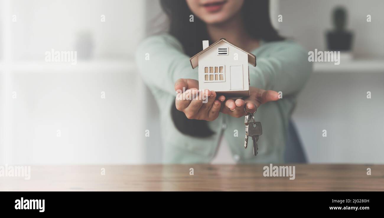 Close up Business woman or Real Estate agent giving house key after ...