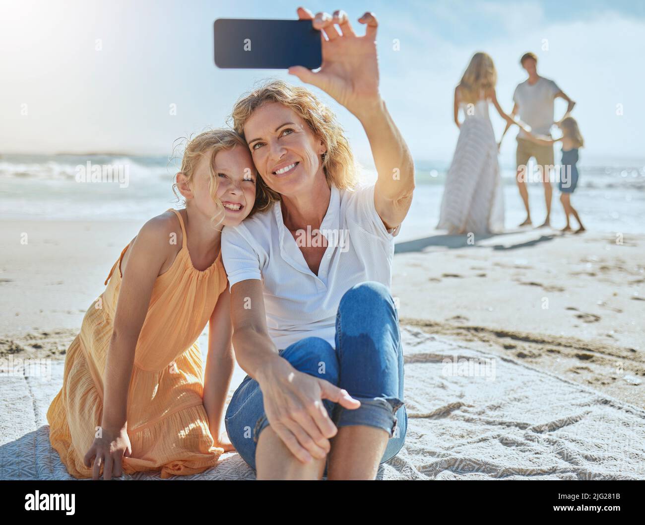 Smiling child looking phone outside hi-res stock photography and images