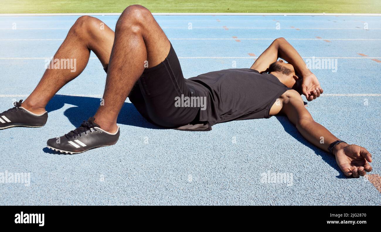 Closeup of a fit active young male athlete lying exhausted flat on the