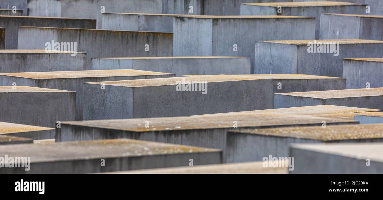 June 28, 2022, Berlin, Germany: General view of concrete slabs or ''stelae'' part of the Memorial to the Murdered Jews of Europe or ''Holocaust Memorial'' located south of the Brandenburg Gate. The Memorial to the Murdered Jews of Europe also known as the Holocaust Memorial is a memorial in Berlin to the Jewish victims of the Holocaust, designed by architect Peter Eisenman and Buro Happold. It consists of a 19,000-square-metre site covered with 2,711 concrete slabs or ''stelae'', arranged in a grid pattern on a sloping field. They are organized in rows, 54 of them going northÃ±south, and 87 he Stock Photo