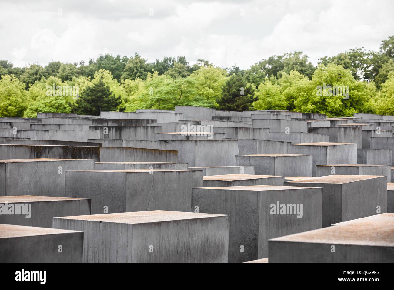 June 28, 2022, Berlin, Germany: General view of concrete slabs or ''stelae'' part of the Memorial to the Murdered Jews of Europe or ''Holocaust Memorial'' located south of the Brandenburg Gate. The Memorial to the Murdered Jews of Europe also known as the Holocaust Memorial is a memorial in Berlin to the Jewish victims of the Holocaust, designed by architect Peter Eisenman and Buro Happold. It consists of a 19,000-square-metre site covered with 2,711 concrete slabs or ''stelae'', arranged in a grid pattern on a sloping field. They are organized in rows, 54 of them going northÃ±south, and 87 he Stock Photo