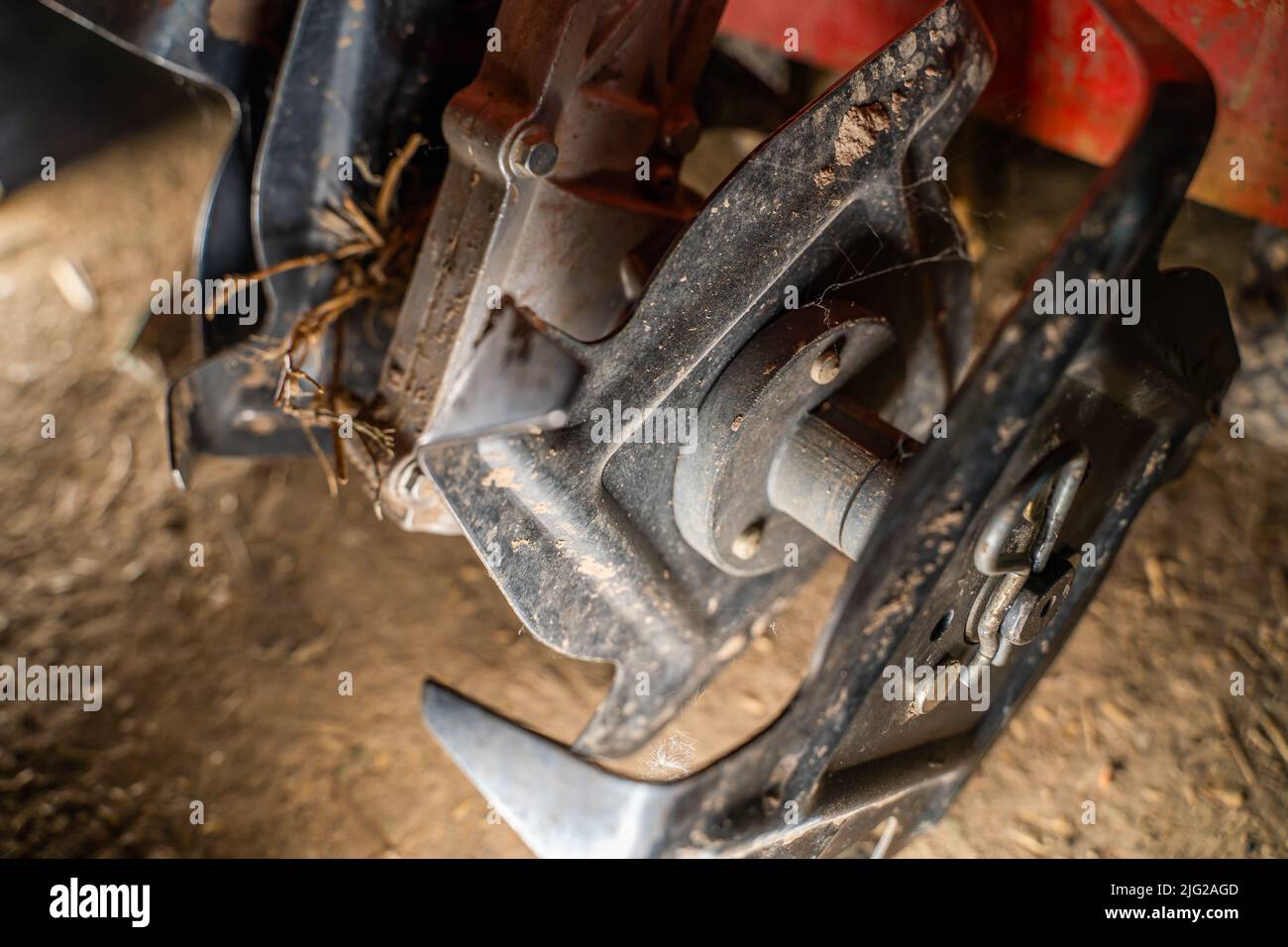 Tiller of a small walkbehind tractor closeup. Manual walkbehind