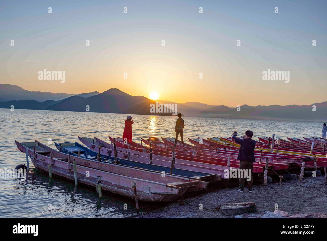 LIJIANG, CHINA - JULY 7, 2022 - Tourists visit the bank of Lugu Lake in Lijiang, Yunnan Province, China, July 7, 2022. Lugu Lake, known as the 'Pearl Stock Photo