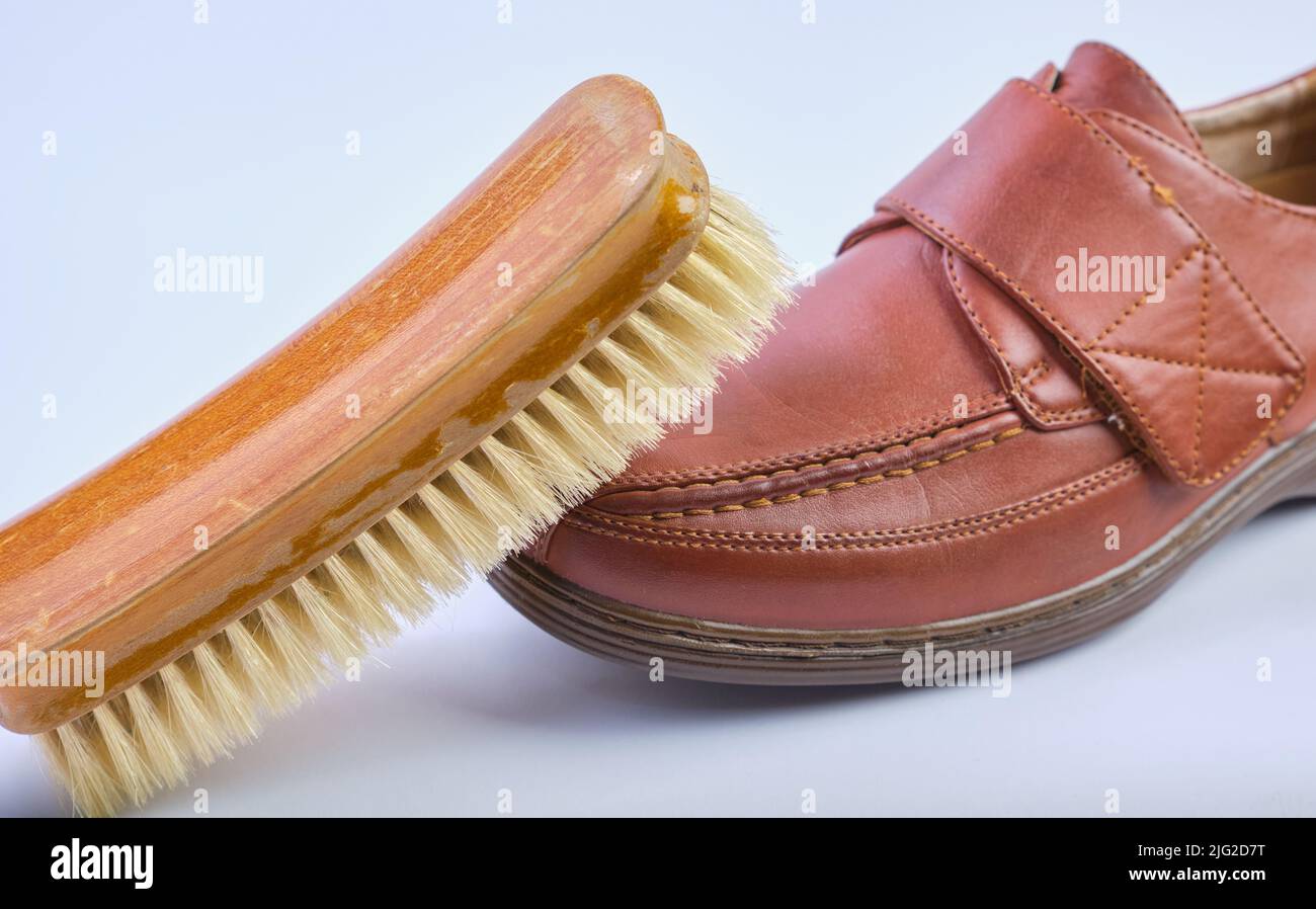 Shoe Brush on top of Tan Cushion casual Walk Touch Fasten Wide Fit Shoe Stock Photo