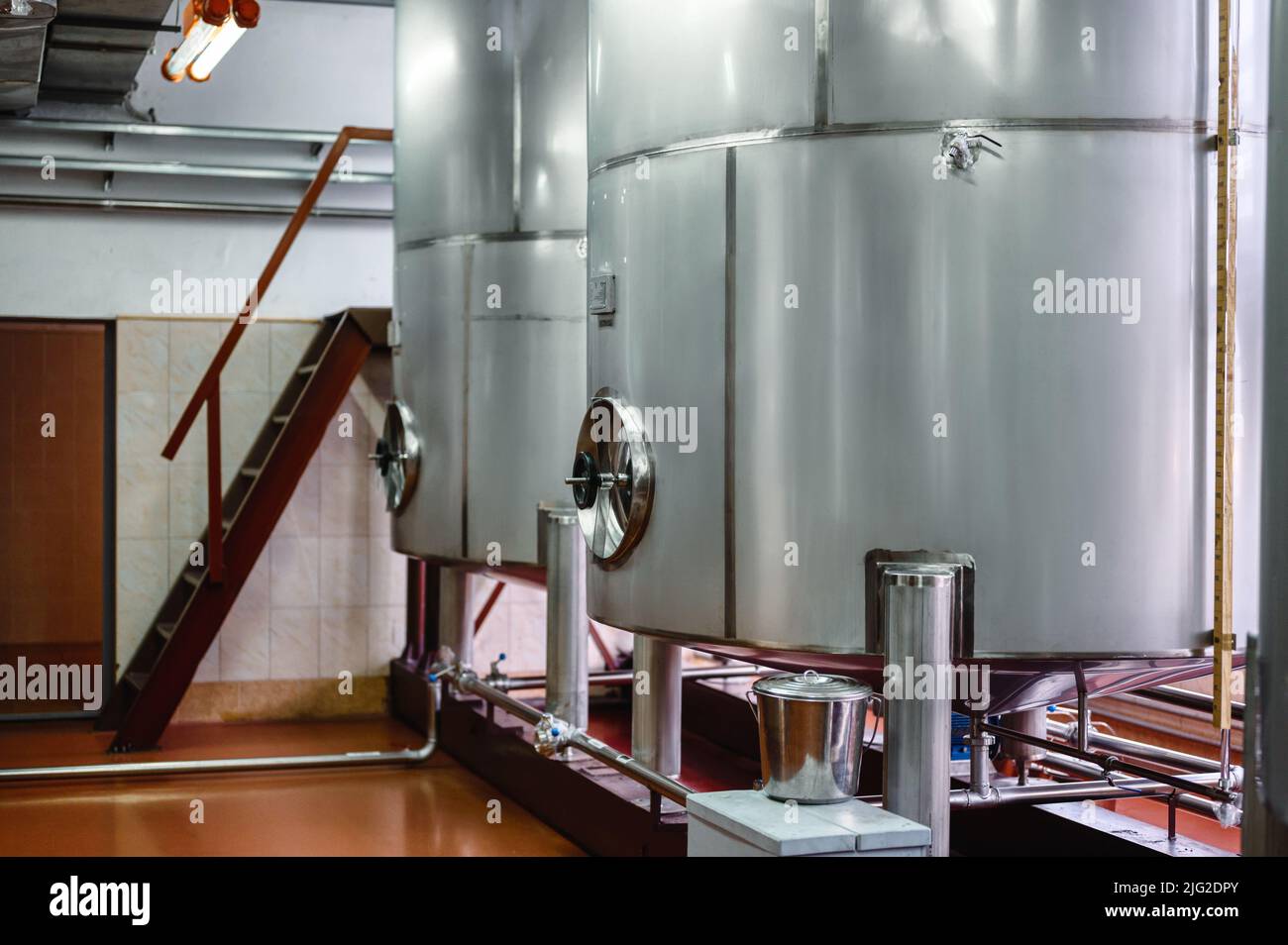 Large metal reservoirs to make alcohol at production plant Stock Photo
