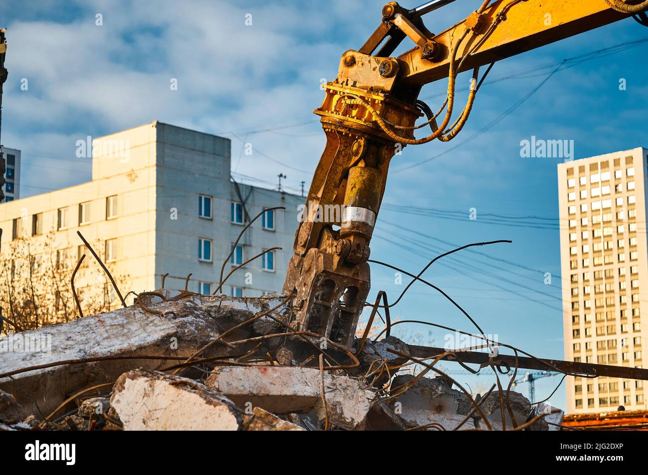 Hydraulic concrete crusher breaks and crushes reinforced concrete Stock