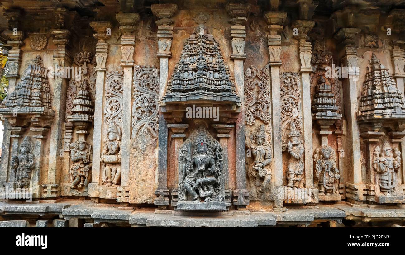 Sculpture of Goddess Kali and other deities under aedicules or shrines shaped like vimanas on the Bucesvara temple, Koravangala, Hassan, Karnataka, In Stock Photo
