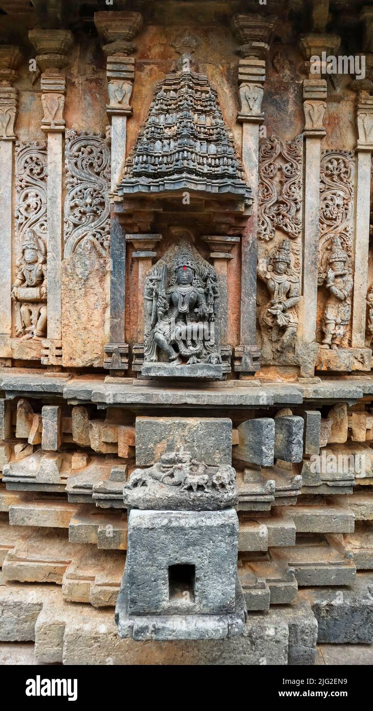 Sculpture of Goddess Kali under an aedicule or shrine shaped like vimana on the Bucesvara temple, Koravangala, Hassan, Karnataka, India. Stock Photo