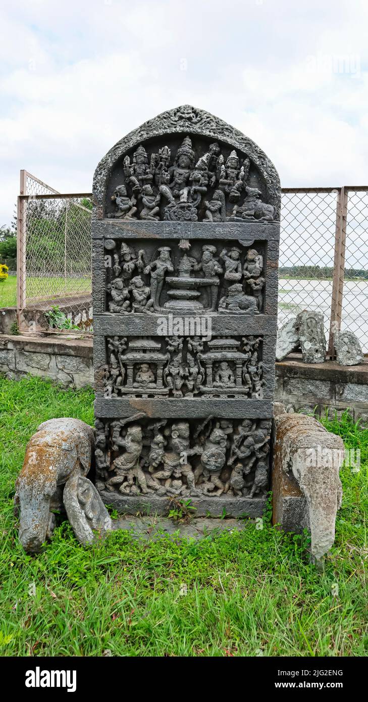 Carved pillar showing worship of Lord Shiva on top and war scenes below, Bucesvara temple, Koravangala, Hassan, Karnataka, India. Stock Photo