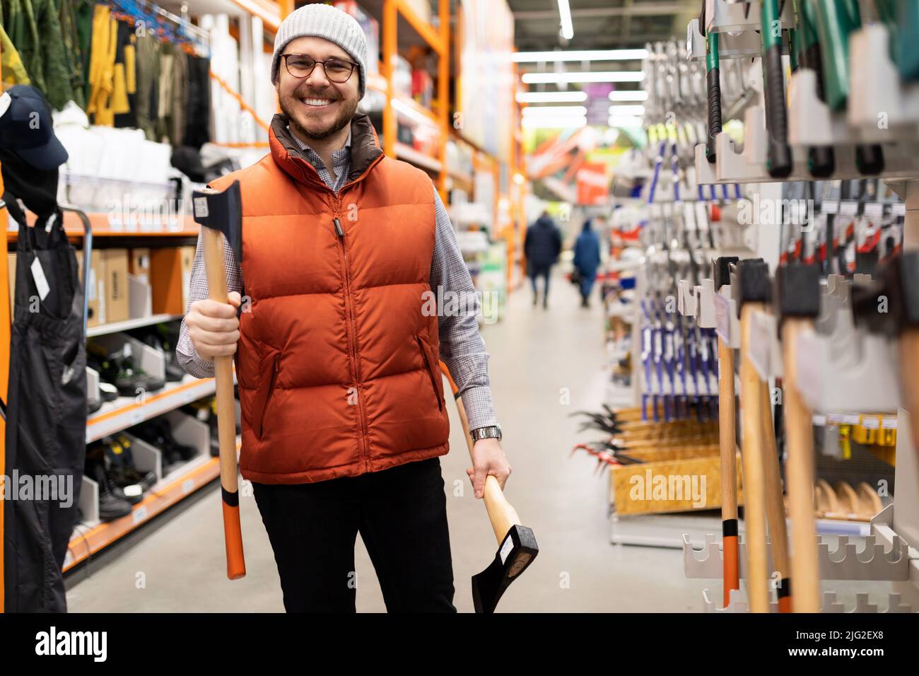 happy customer in a hardware store buying a new ax Stock Photo Alamy