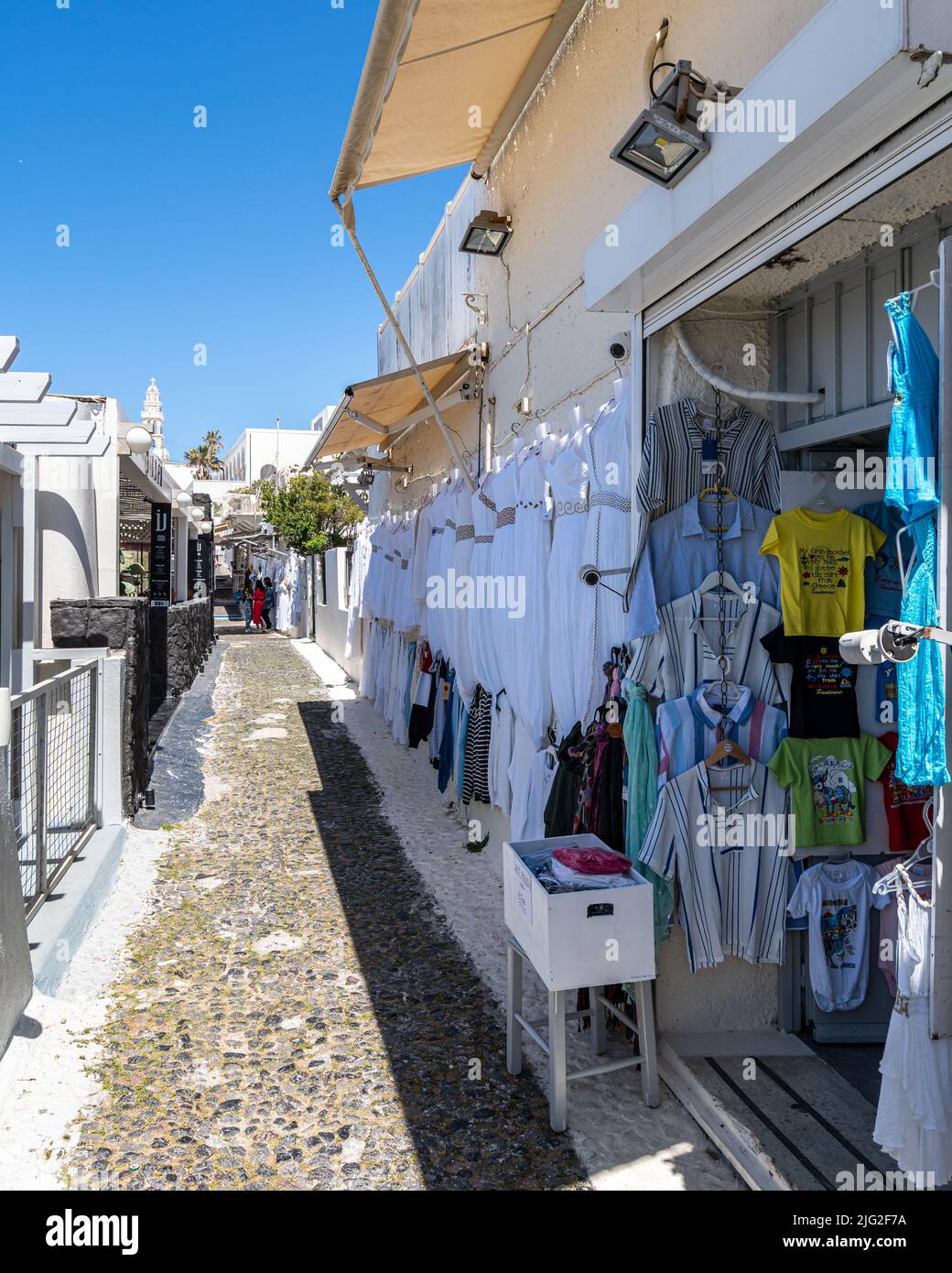 Fira, Santorini, Greece, Apr. 2022 - An alley with typical shops in Fira, the main town of Santorini island Stock Photo