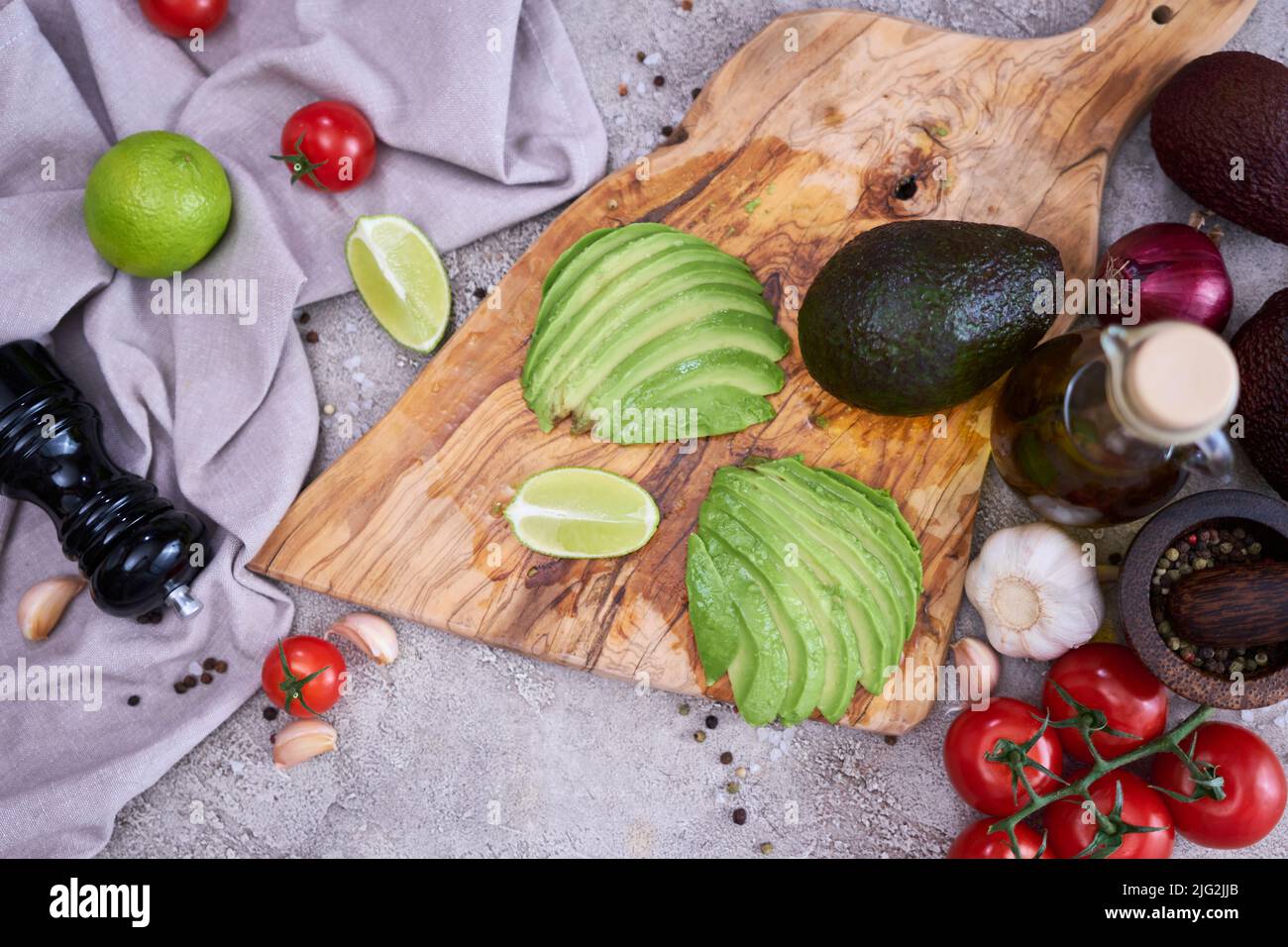 Sliced avocado on wooden cutting board at domestic kitchen Stock Photo ...