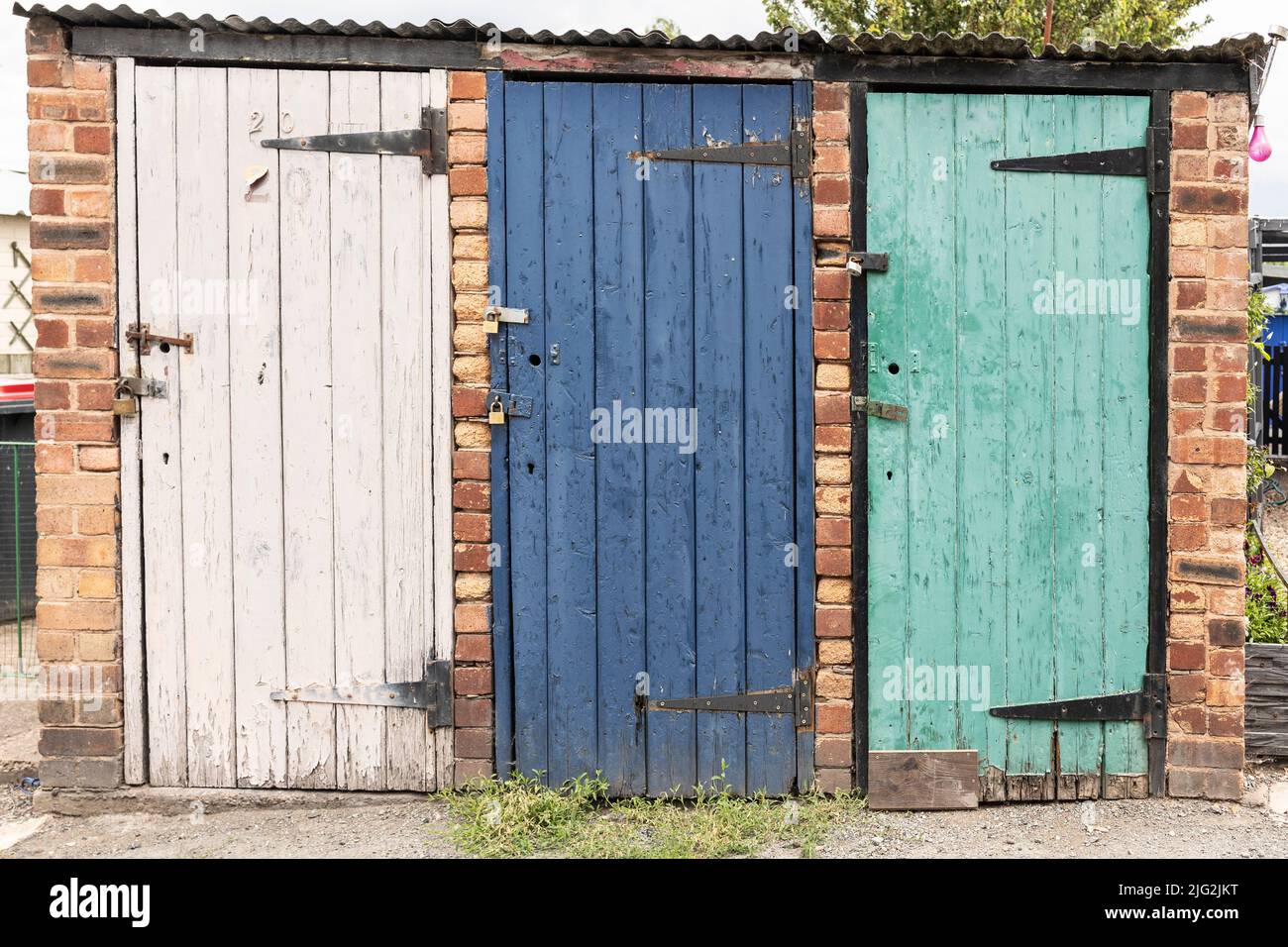 vintage coal bunkers with multicoloured and weathered doors Stock Photo