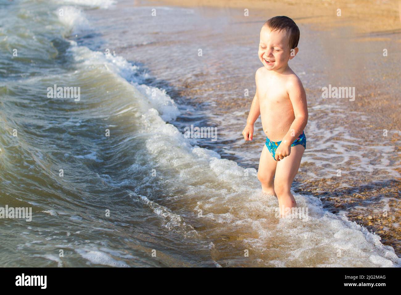 a little boy having fun in the sea on the waves. Stock Photo
