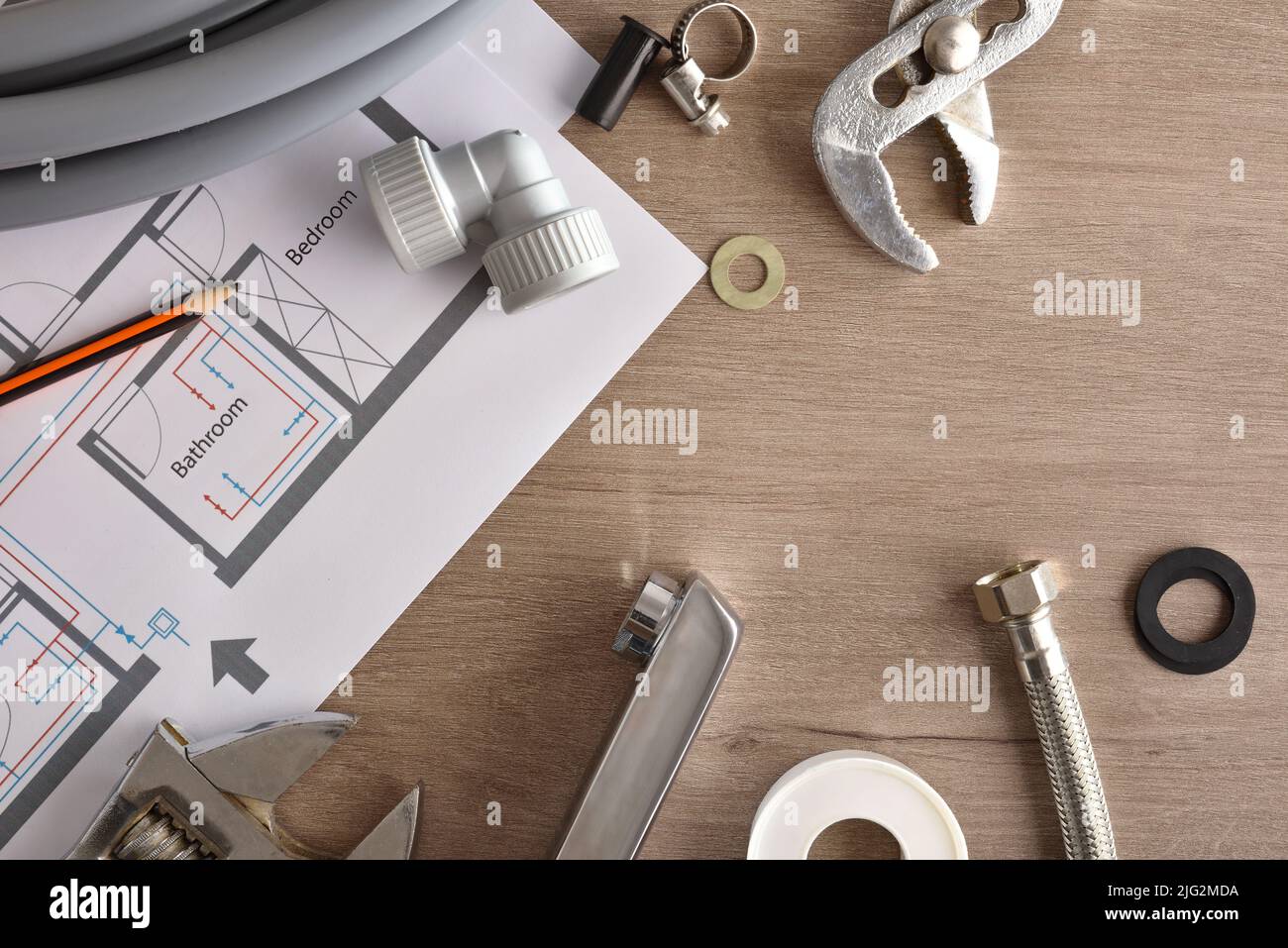 Maintenance of home plumbing with material and tools on wooden table