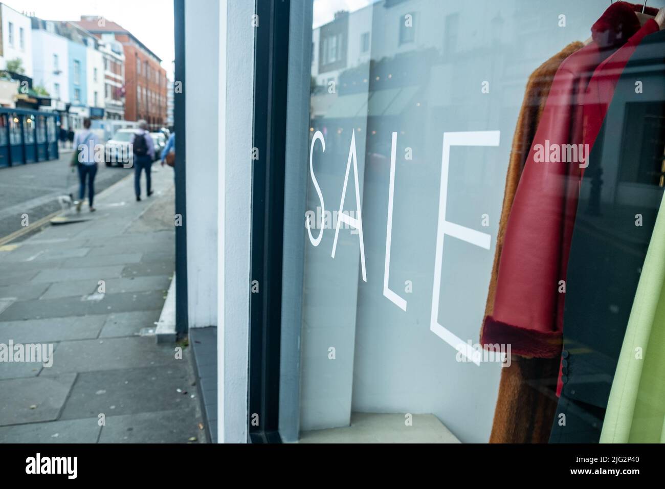 High Street clothes store with ‘Sale’ text in shop window Stock Photo