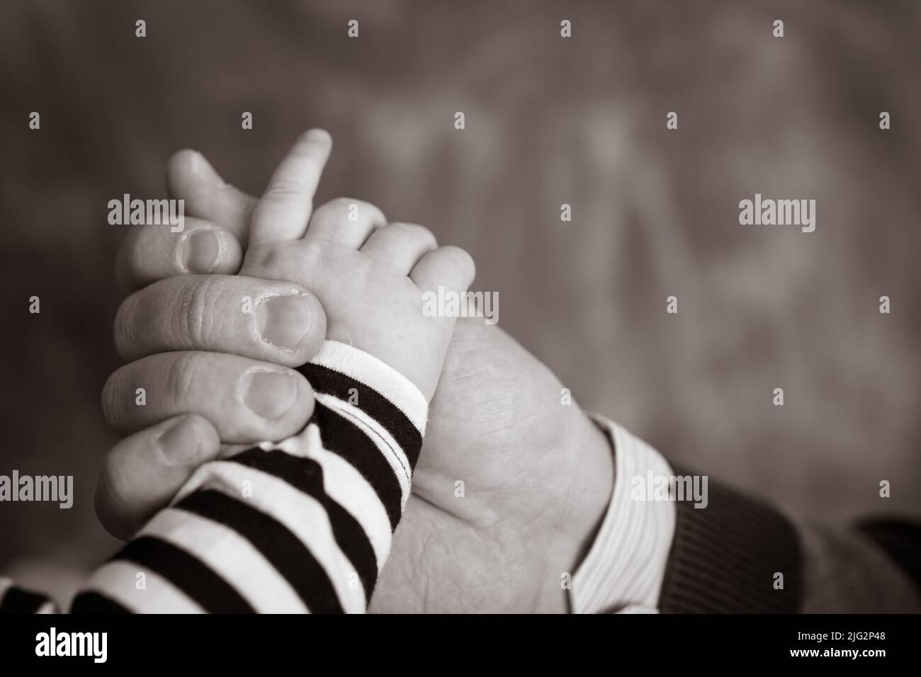 Little hand of the child in the fathers hand Stock Photo