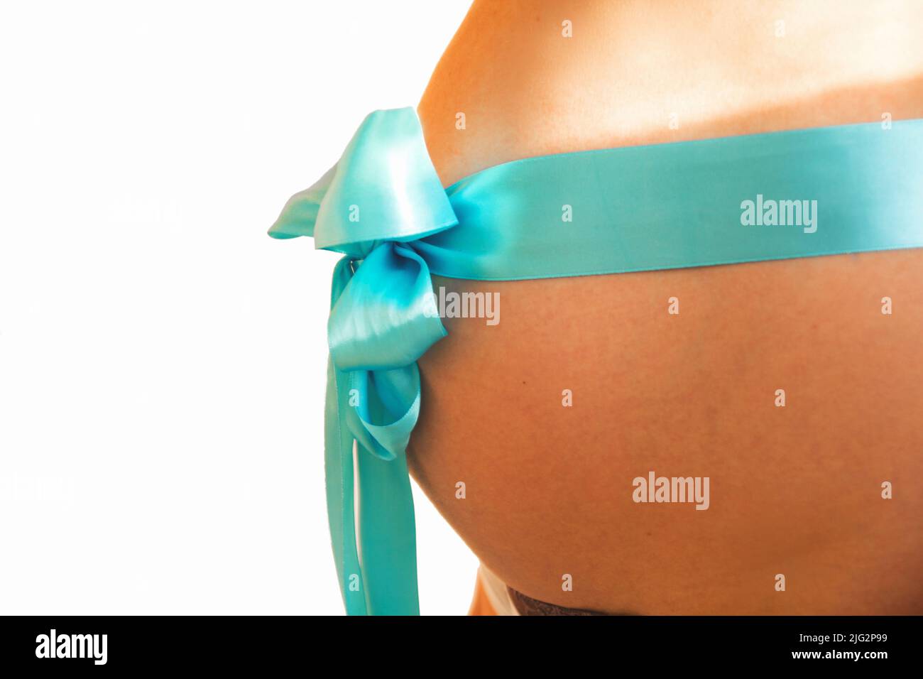 belly of a pregnant girl with a blue ribbon Stock Photo