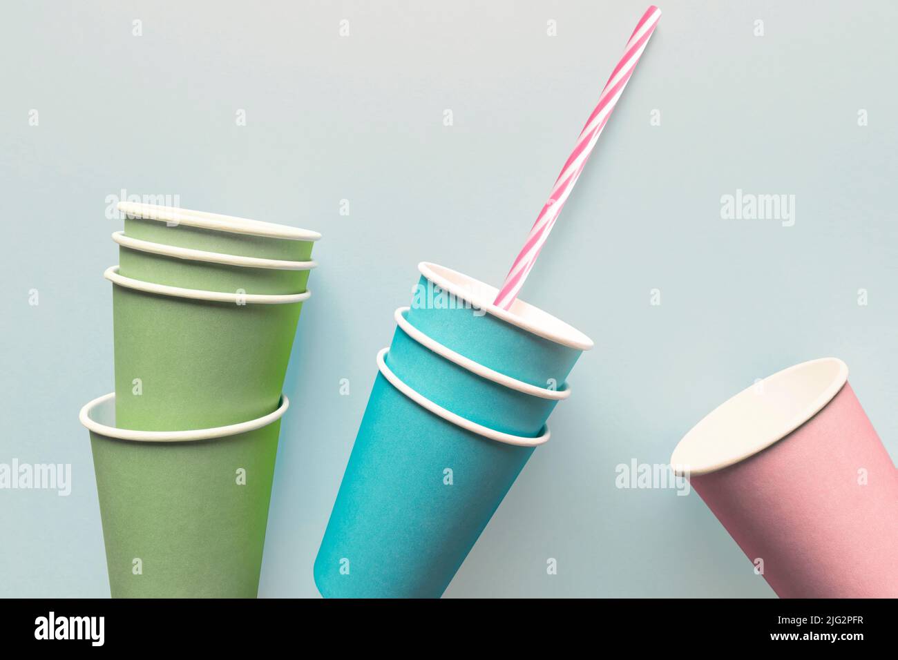 Close-up of paper cups with drinking straw, isolated on light blue ...