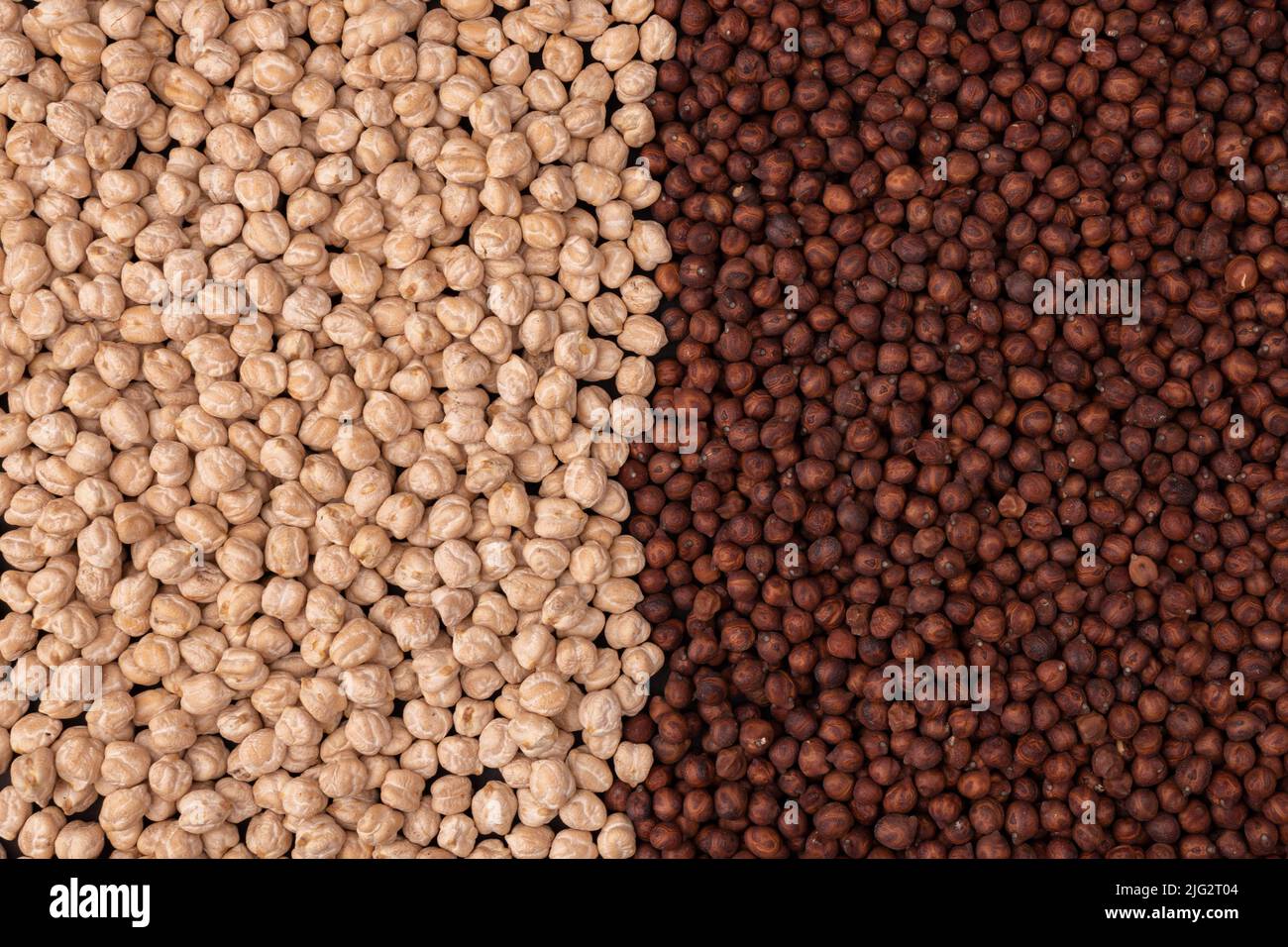 dark and white chickpeas, different types of legumes and cereals as background, top view, organic grains Stock Photo