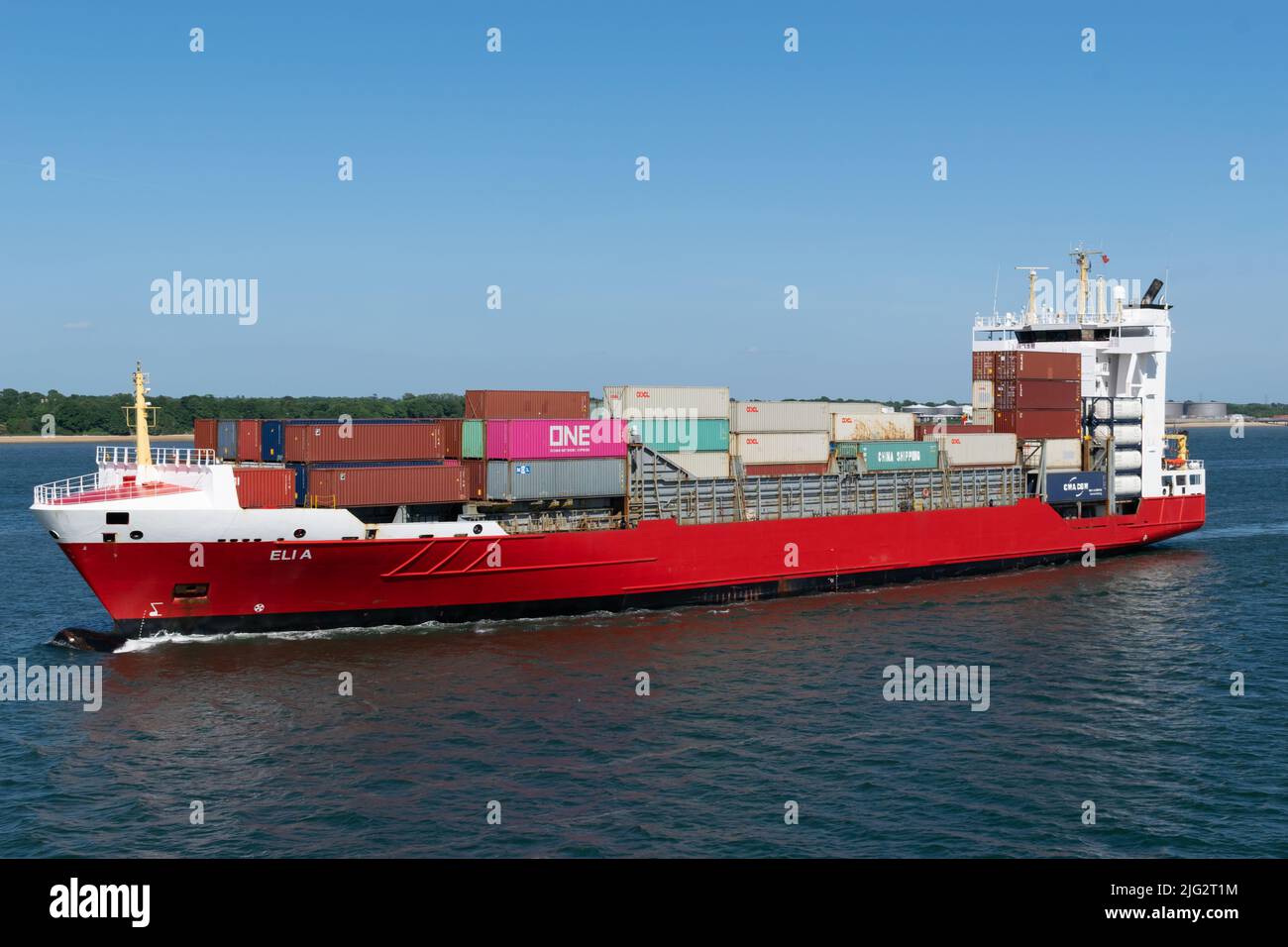 ELI A container ship sailing in the Solent with pink container of Ocean Network Express and text ONE Stock Photo