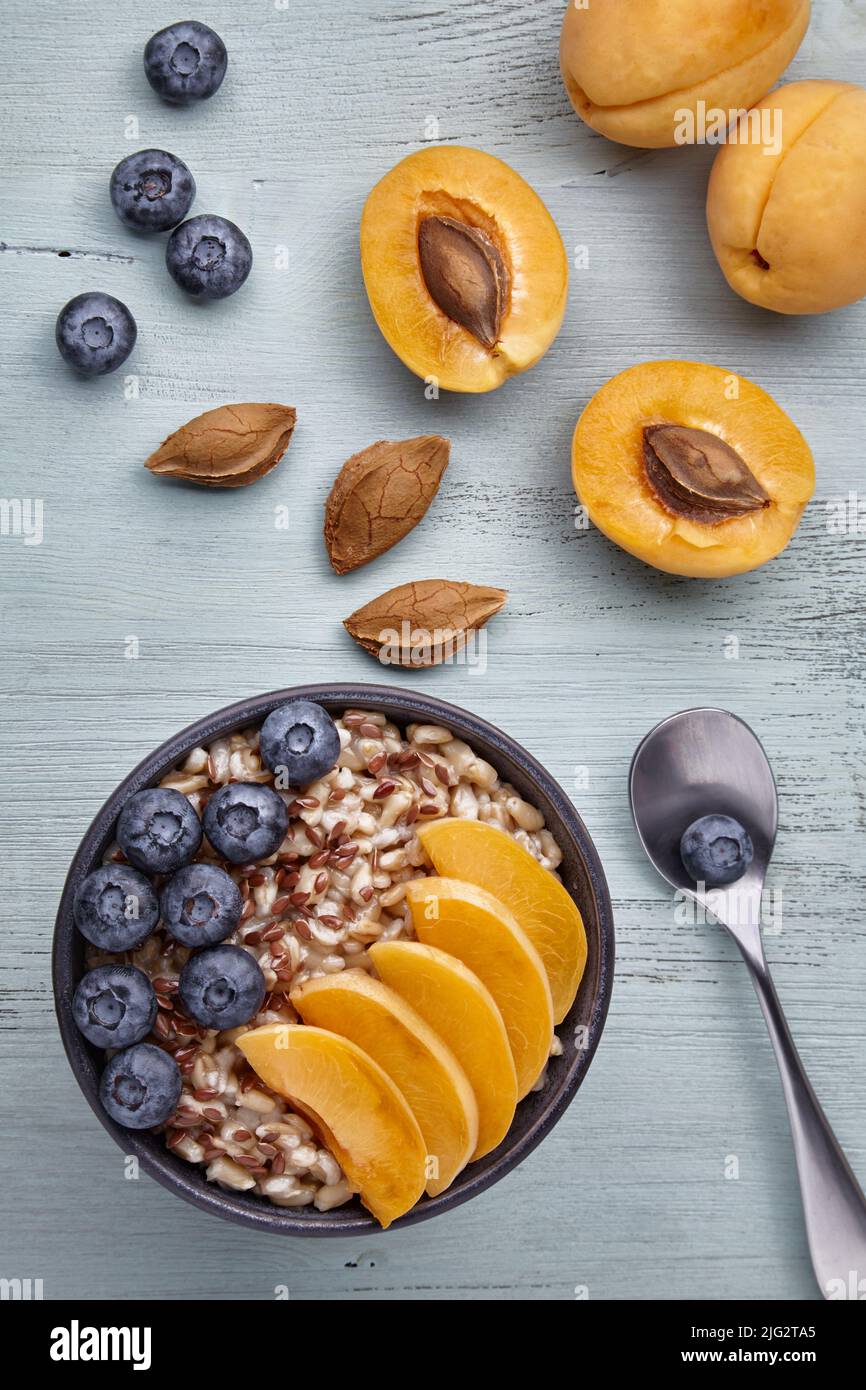 Vegetarian breakfast. Whole grain oatmeal with apricot slices and