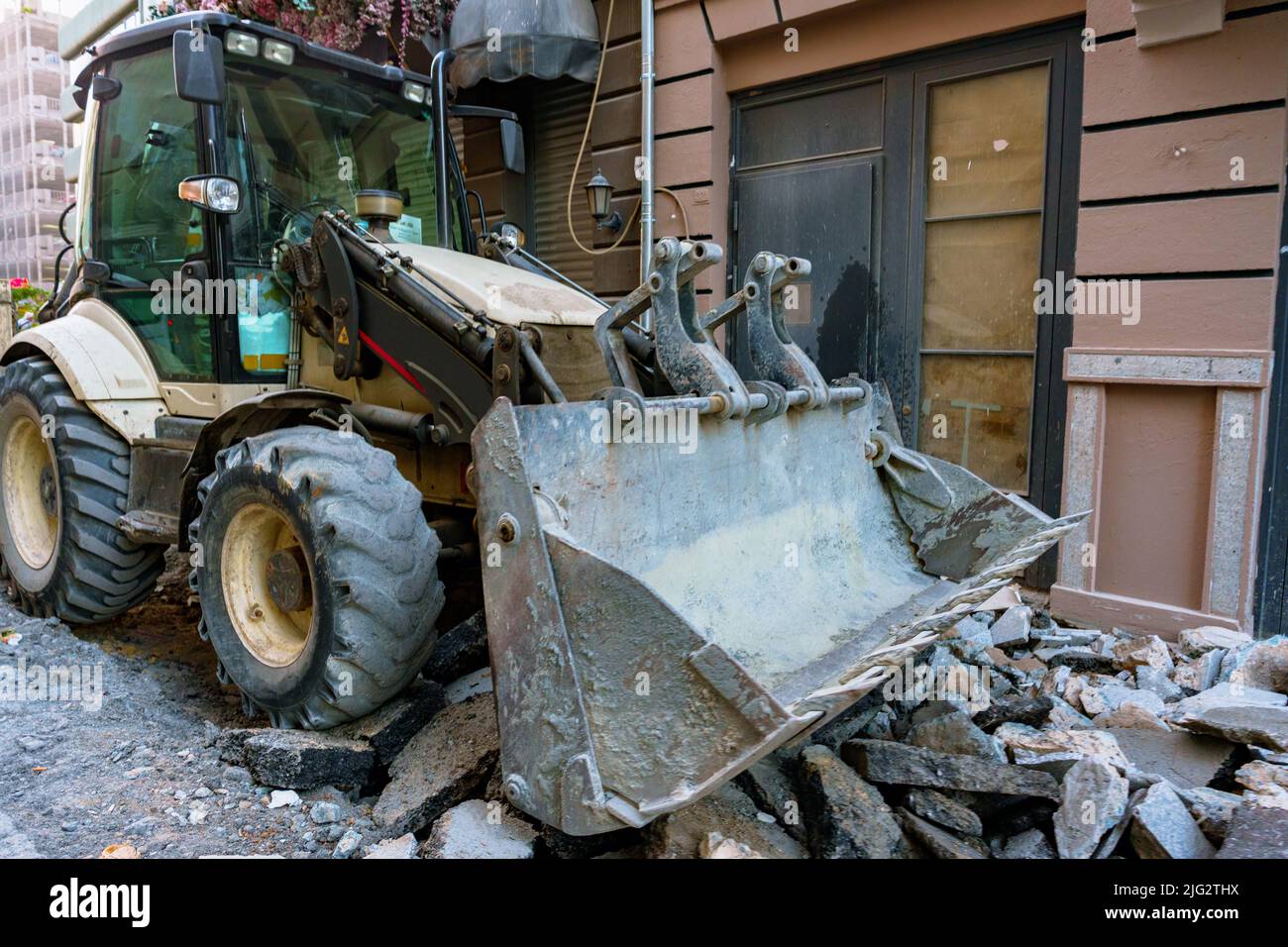 The tractor removing concrete debris and paving slabs Stock Photo Alamy