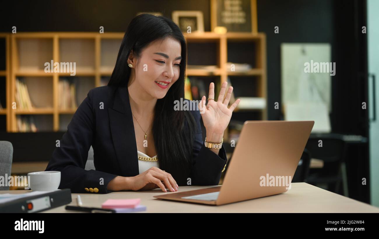 Asian businesswoman communicating by video conference, distance job interview via laptop computer Stock Photo