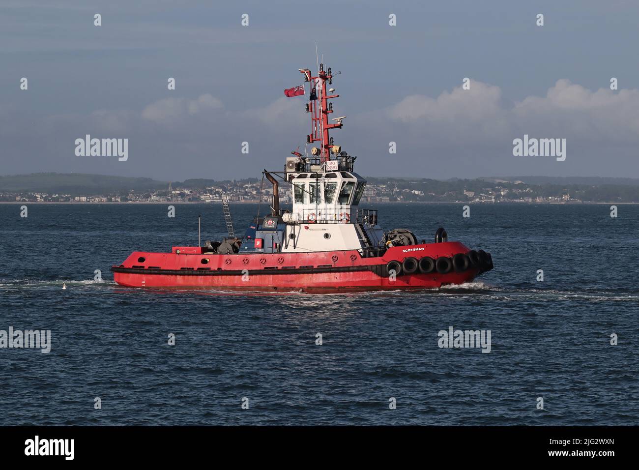 The port tug SCOTSMAN approaching the harbour entrance. The vessel is operated by the SMS Towage company Stock Photo