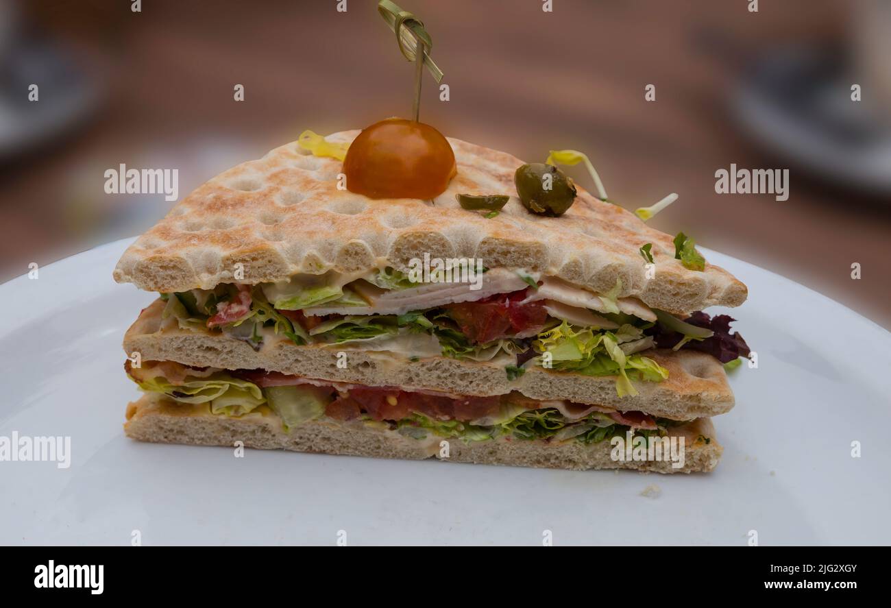 white plate wich healthy sandwich wit lettuce tomato and others on a bread Stock Photo