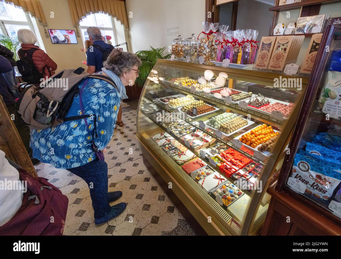 Estonia tourist; a woman shopping for sweets, chocolates and marzipan candy, Cafe Maiasmokk interior, Tallinn old town, Tallinn Estonia Stock Photo