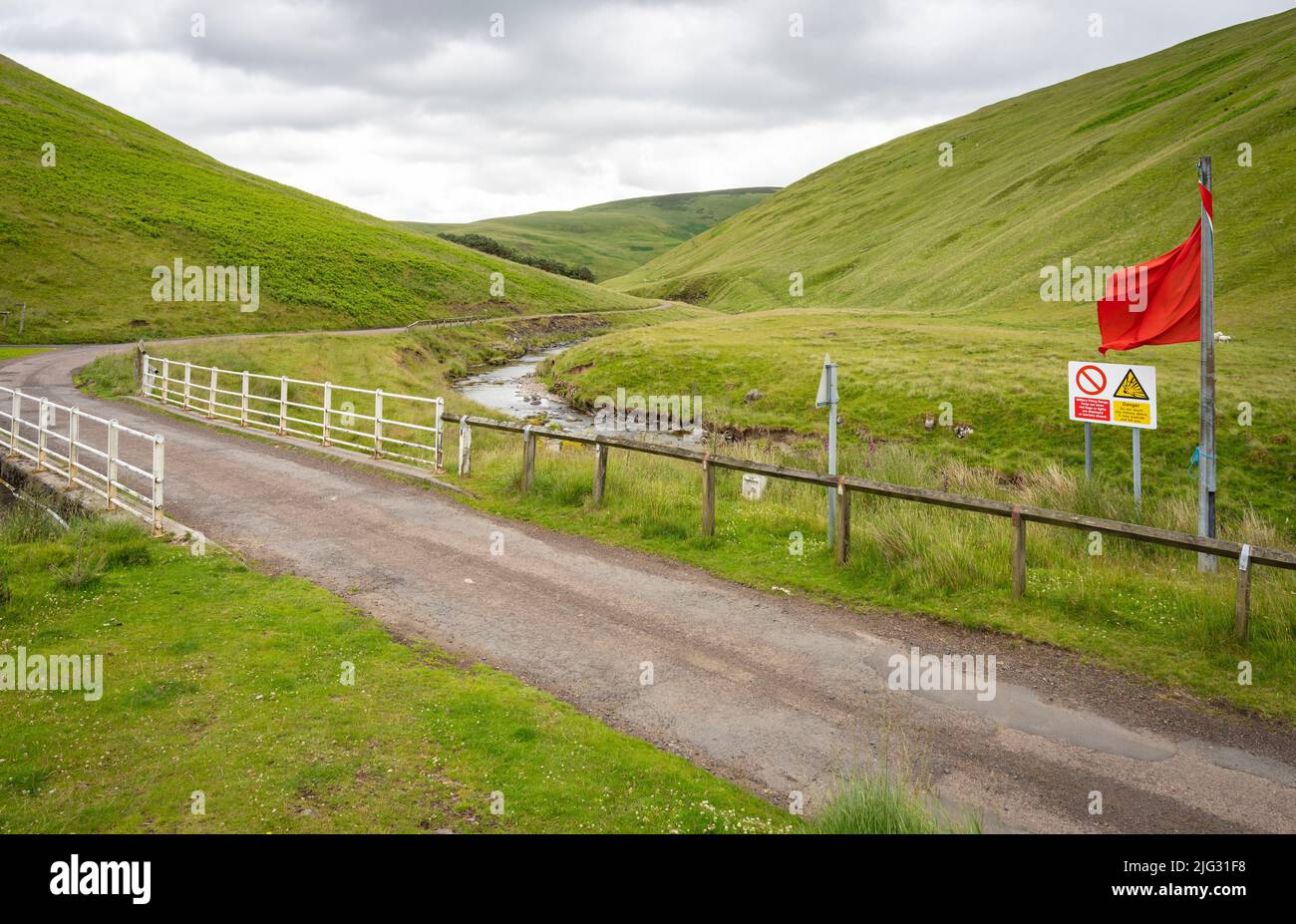 Red flag and danger sign in the Otterburn military range in Northumberland National Park. Stock Photo