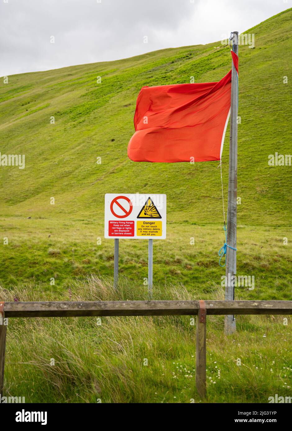 Red flag and danger sign in the Otterburn military range in Northumberland National Park. Stock Photo