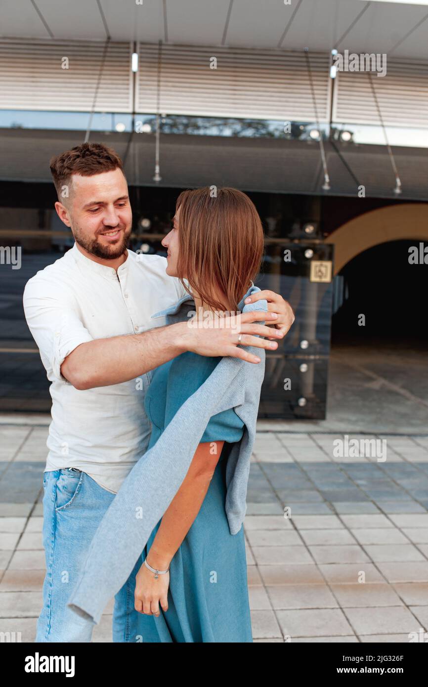 Romantic young couple in love hugging on the street Stock Photo