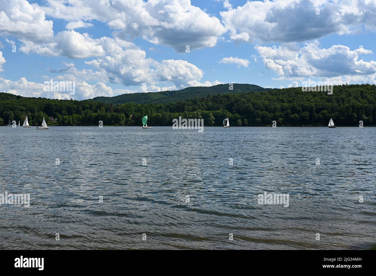 View of the lake Edersee with sailing boats, blue sky and clouds, in Hesse, Germany Stock Photo