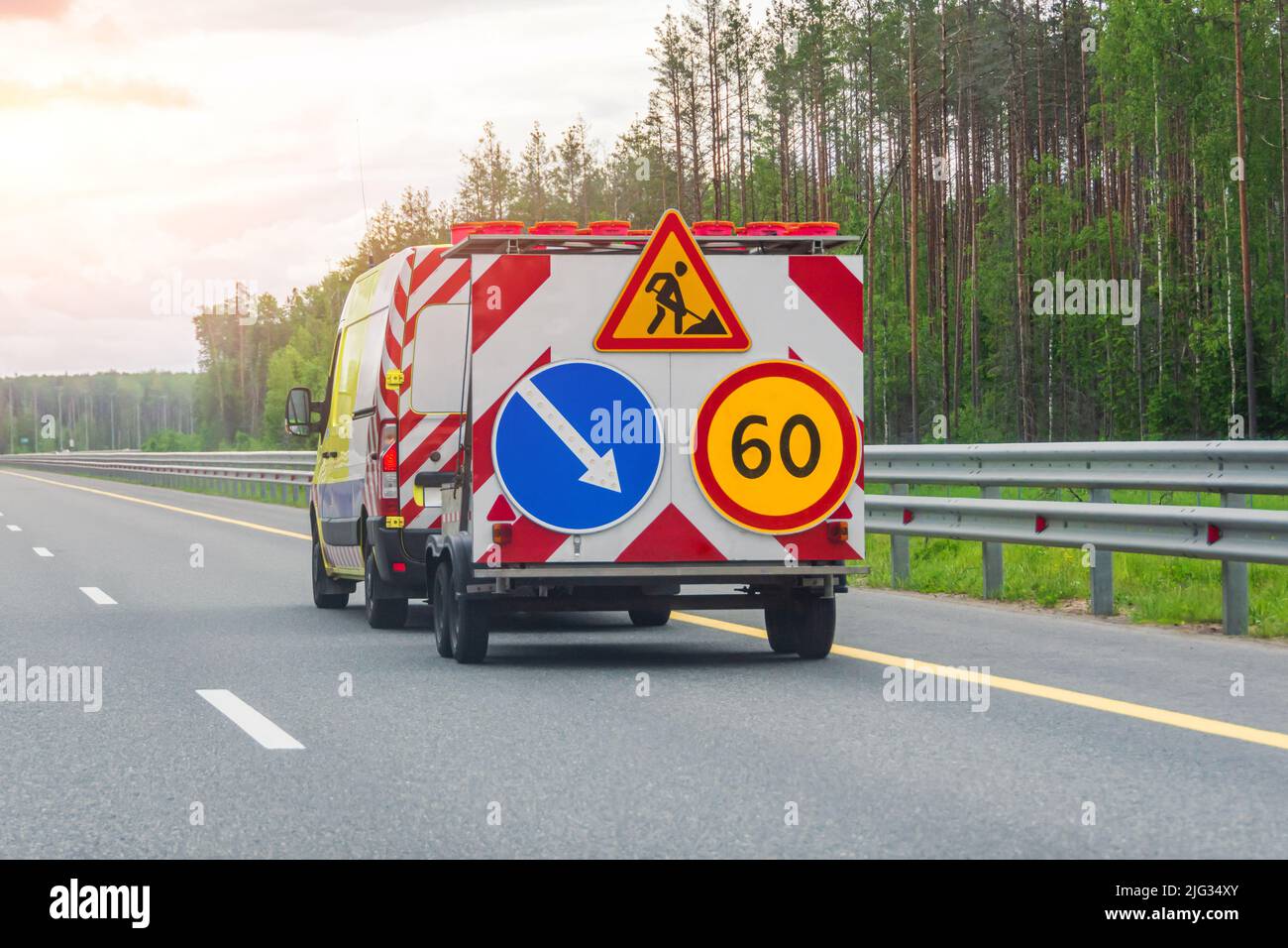 Road services vehicle with trailer and speed limit and lane maintenance