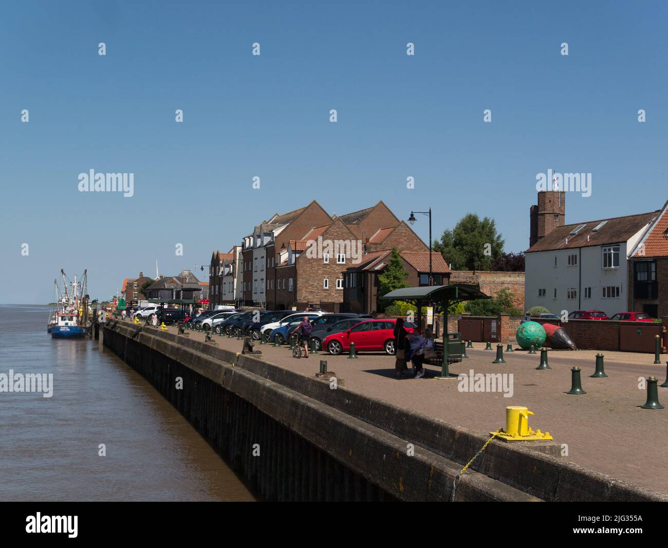 View along King's Lynn quaysidewith fishing boats  moored in Great Ouse River Norfolk England UK Stock Photo