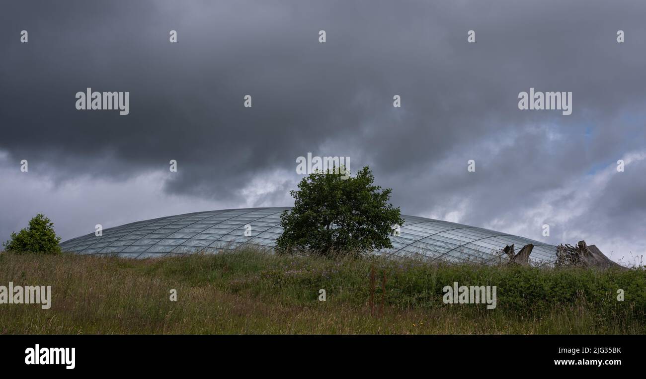 Photo taken at the National Botanic Garden Wales in July 2022 and showing dark skies over the glasshouse. Stock Photo